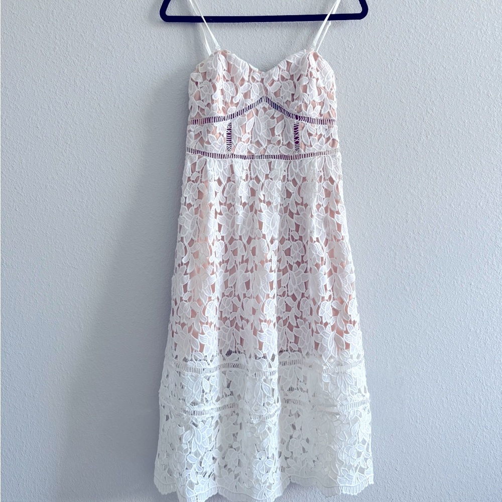 White floral lace overlay midi dress with a blush/nude lining underneath.